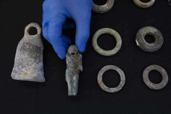 Jacob Sharvit, director of the Marine Archaeology Unit of the Israel Antiquities Authority holds the finds made near the ancient city of Caesarea , dated to the Roman and Mamluk periods, around 1,700 and 600 years ago.