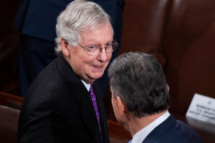 Senate Majority Leader Mitch McConnell, R-Ky., and Joe Manchin, D-W.Va., speak with each other in the House Chamber on Tuesday, February 4, 2020.