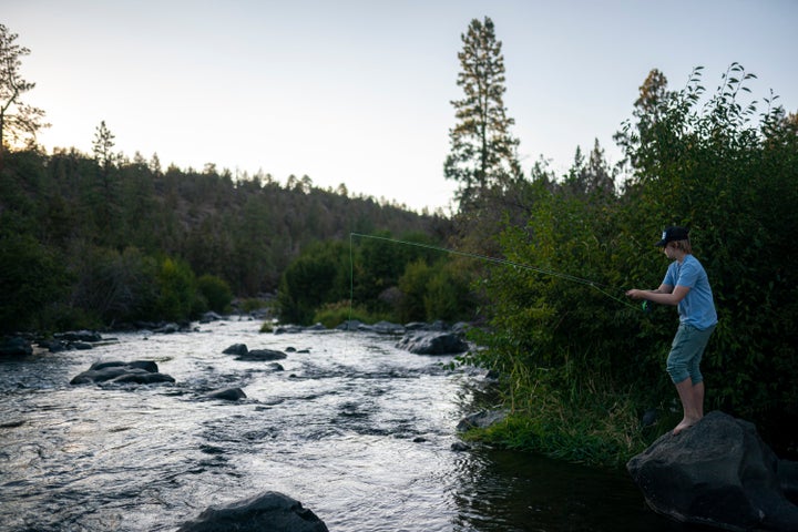 A man fly fishes along the Deschutes River in Bend, Oregon, in August. McLeod-Skinner hopes that her roots in central Oregon will give her an edge over Schrader.
