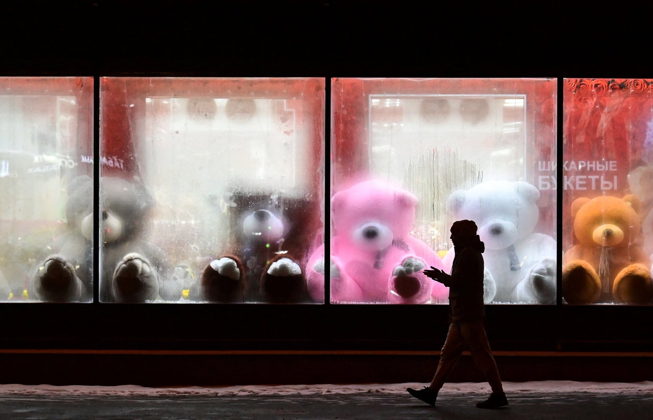A pedestrian walks past a shop window with teddy bears as decoration ahead of the Christmas festivities in Moscow on Monday.