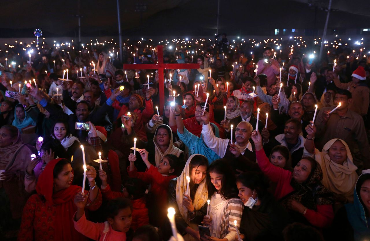 Pakistani Christians hold candles during a celebration for Christmas, in Lahore, Pakistan, on Wednesday.