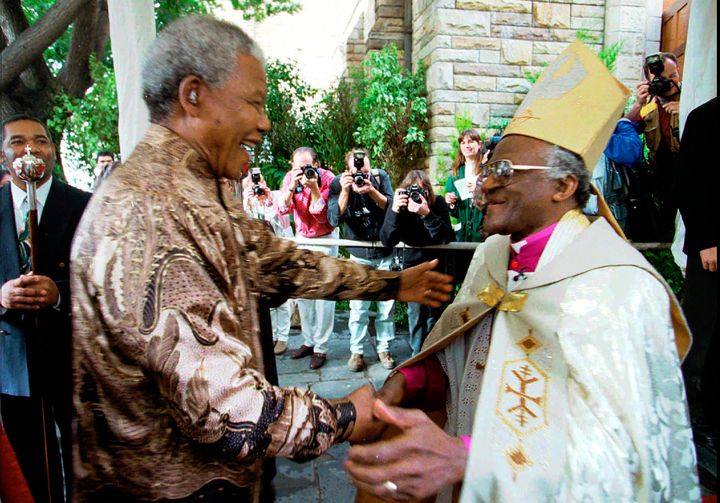 Retiring Archbishop of Cape Town Desmond Tutu (right) greets President Nelson Mandela at 1996 service in Cape Town held to celebrate the end of Tutu's tenure as leader of the Anglican Church in South Africa.
