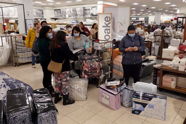 Customers wait in line to checkout during a Black Friday sale at Macy's, Friday, Nov. 26, 2021, in Indianapolis. (AP Photo/Darron Cummings)