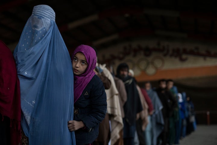 Women queue to receive cash at a money distribution organised by the World Food Program in Kabul, Afghanistan, on Saturday, Nov. 20, 2021. (AP Photo/Petros Giannakouris)