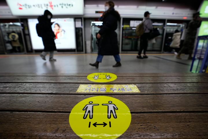 Social distancing signs on precautions against the coronavirus are displayed on a chair at a subway station in Seoul, South Korea, Monday, Dec. 27, 2021. The signs read "Keep your distance." (AP Photo/Ahn Young-joon)