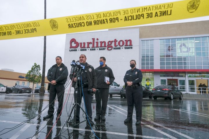 Los Angeles Police Department Public Information Officer Capt. Stacy Spell, second from left, speaks in a press conference at the scene where two people were struck by gunfire in a shooting at a Burlington store — part of a chain formerly known as Burlington Coat Factory in North Hollywood, Calif., Thursday, Dec. 23, 2021. (AP Photo/Ringo H.W. Chiu)