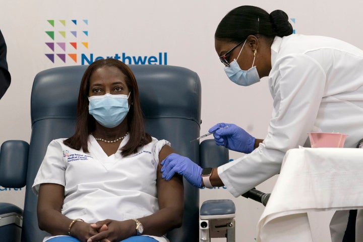 FILE - In this Dec. 14, 2020, file photo, Sandra Lindsay, left, a nurse at Long Island Jewish Medical Center, is inoculated with the Pfizer-BioNTech COVID-19 vaccine by Dr. Michelle Chester, in the Queens borough of New York. Smithsonian’s Museum of American History has acquired the vial that contained the very first dose of COVID-19 vaccine administered in the United States.