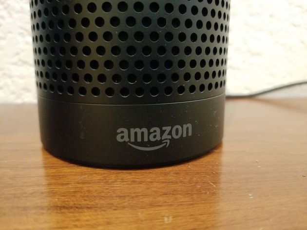 Close-up of the base of an Amazon Echo smart speaker using the Alexa service, with Amazon logo visible,...