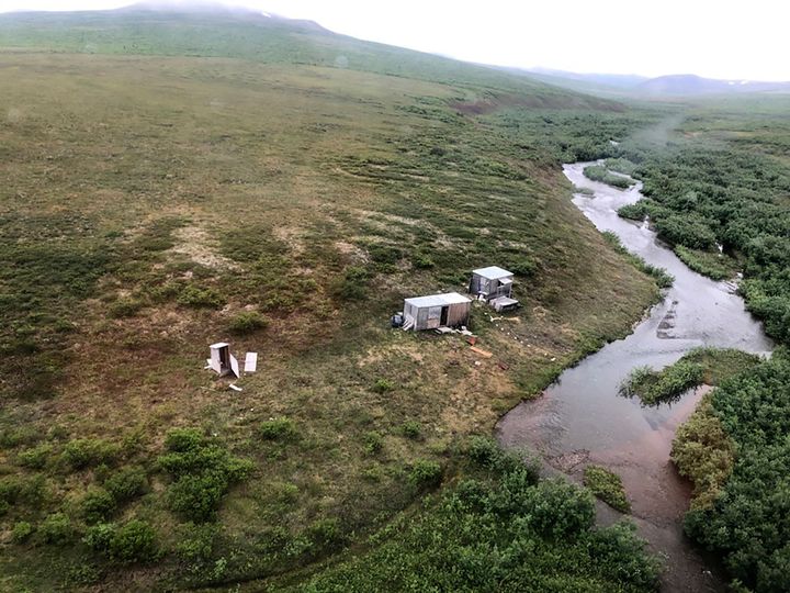 This photo provided by the U.S. Coast Guard District 17 shows a remote mining camp near Nome, Alaska, where a Coast Guard Air Station Kodiak aircrew rescued a survivor of a bear attack, on July 16, 2021. A miner who said he was harassed by a bear for seven straight nights in the tundra near Nome was rescued when a passing Coast Guard helicopter spotted the SOS, an internationally recognized sign for help, on top of his cabin. (U.S. Coast Guard via AP)