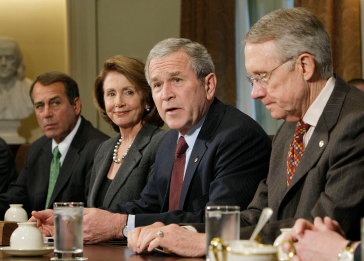Then-Senate Majority Leader Harry Reid, right, looks nonplussed seated next to then-President George W. Bush during discussions about the economy in January 2008. Also in attendance were then-House Minority Leader John Boehner (R-Ohio), left, and Speaker of the House Nancy Pelosi (D-Calif.), second from left.