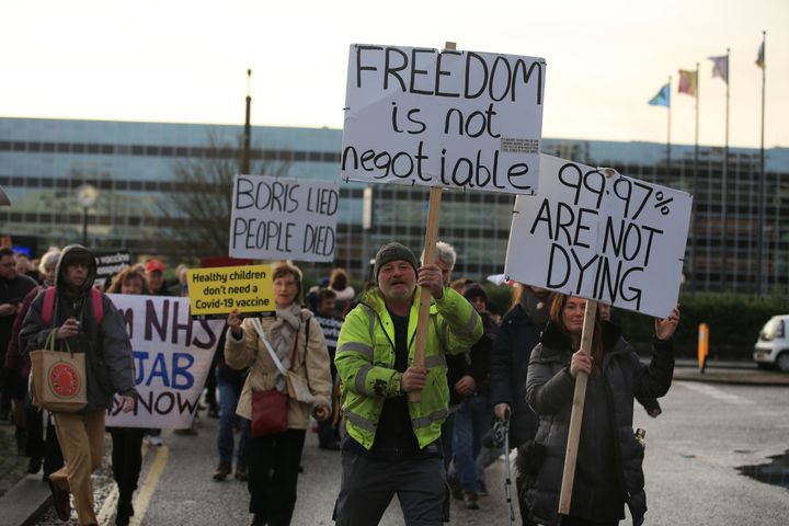 Protesters hold placards as they gather at beginning of the rally in Milton Keynes.