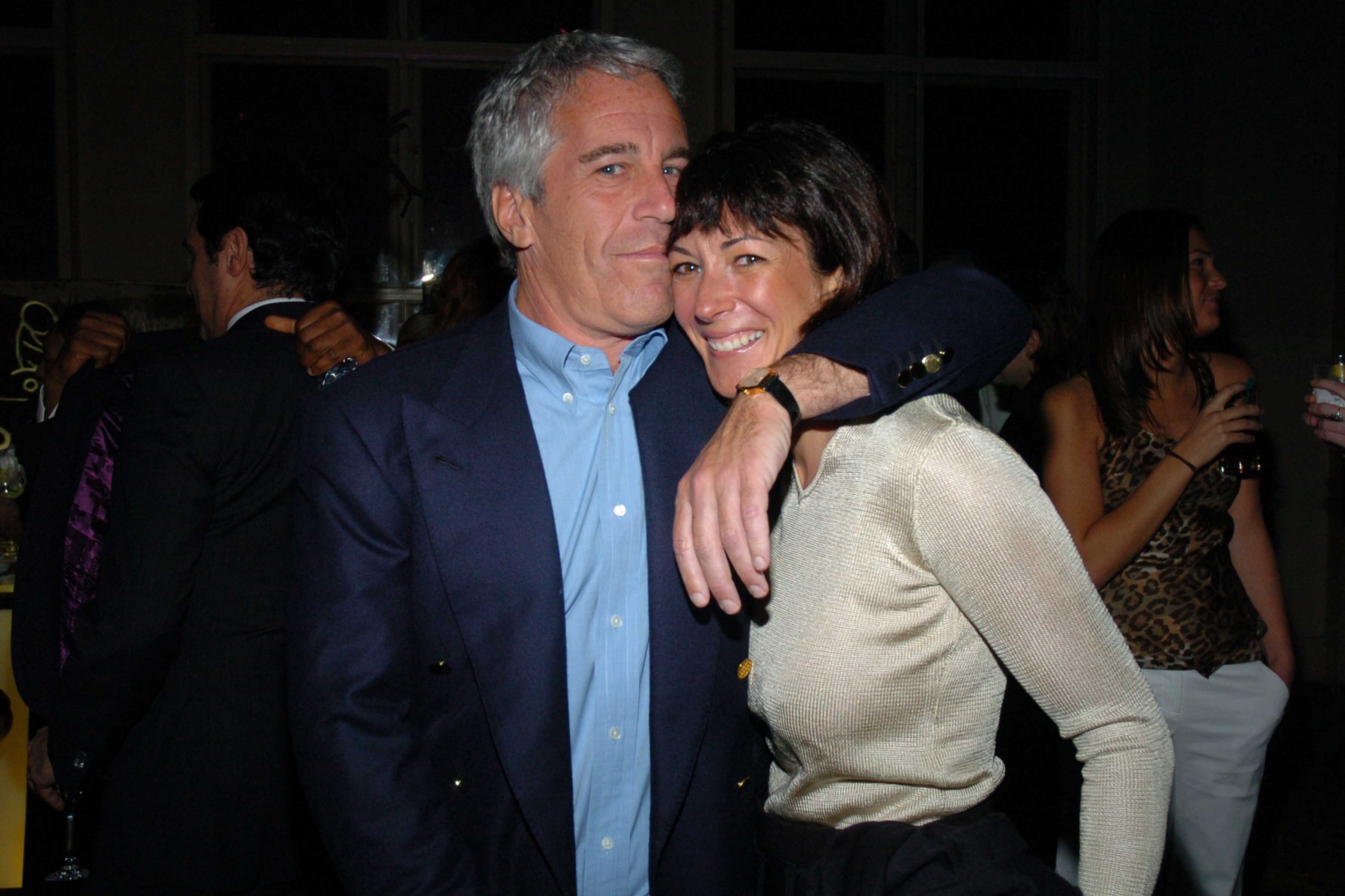 Jeffrey Epstein, left, with arm around Ghislaine Maxwell, right.