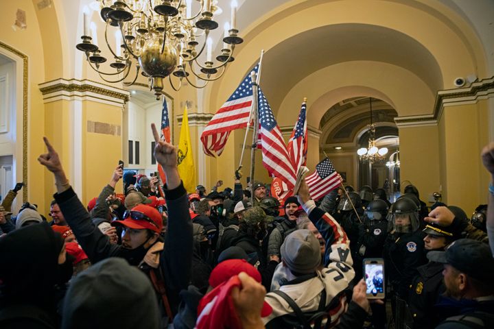 Supporters of Donald Trump stream into a hallway on the ground floor of the U.S Capitol on January 6, 2021. (Photo by Brent Stirton/Getty Images)