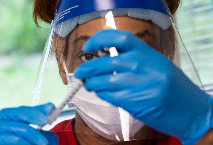 A woman prepares a COVID-19 vaccination at a vaccination clinic in Fairfax, Virginia, on May 13, 2021.