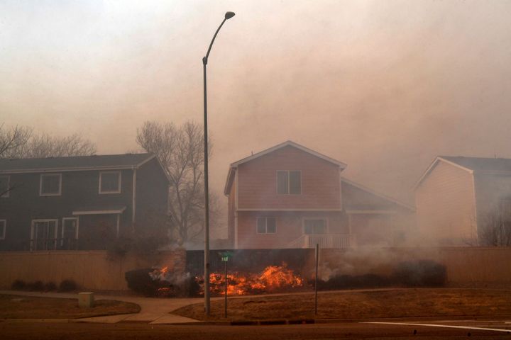 Fires burn fences in neighborhoods on December 30, 2021 in Superior, Colorado.  Several homes and businesses were burned by the rapid fire filled with strong winds with gusts of up to 100 mph.