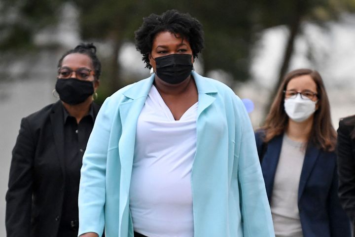 US politician and voting rights activist Stacey Abrams (C) arrives to meet with US President Joe Biden at Emory University in Atlanta, Georgia on March 19, 2021.