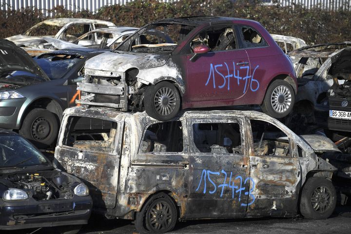 A picture taken on January 1, 2022 in a car breakers yard shows burnt-out cars collected by city employees after the New Year's Eve in the eastern French city of Strasbourg. 