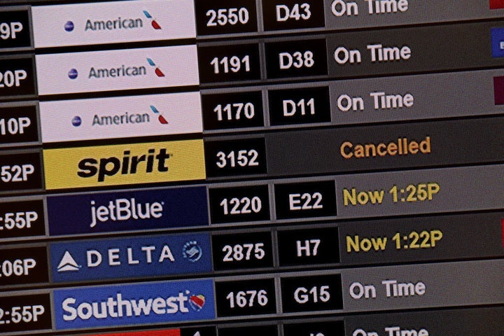 A Spirit airlines flight is shown as cancelled on the flight information board at Miami International Airport on December 28, 2021 in Miami, Florida.