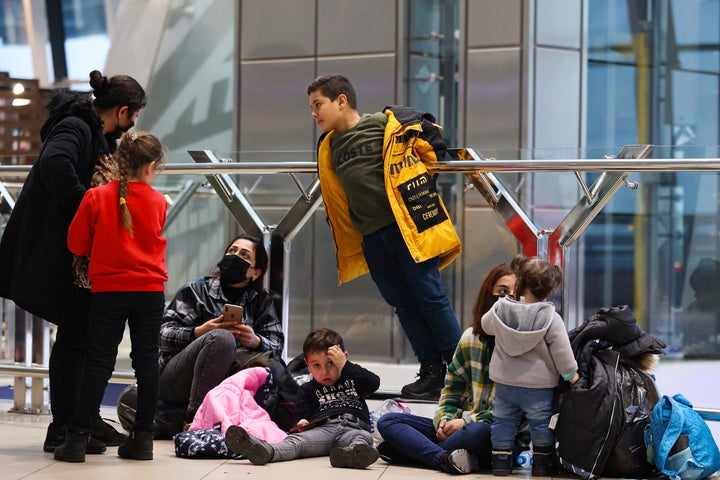 Migrants from Iraq lineup to be registered on a special flight to Iraq at the National Airport outside Minsk, Belarus, Thursday, Nov. 18, 2021.