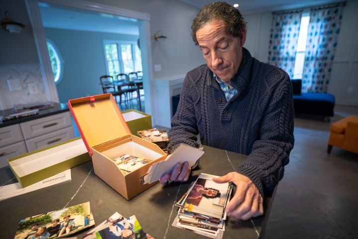 Rep. Jamie Raskin goes through some family photos with a visitor, focusing on the memory of his son, Tommy.