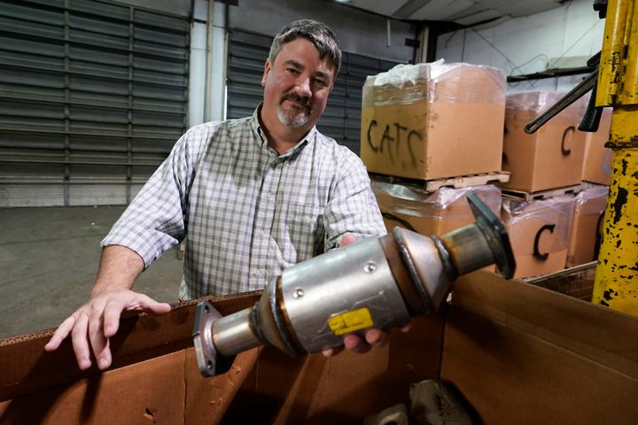 Troy Webber, owner of Chesterfield Auto Parts, holds a used catalytic converter that was removed from one of the cars at his salvage yard on Dec. 17, 2021, in Richmond, Virginia.