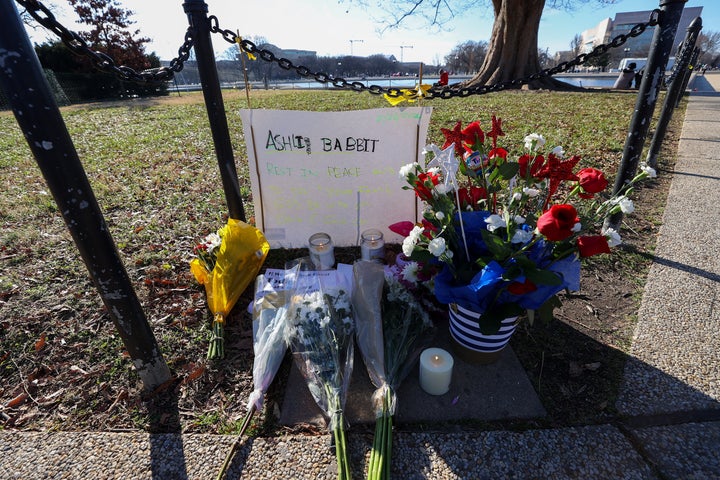 People place flowers and candles for Ashli Babbit, an Air Force veteran who was shot and killed in the U.S Capitol building on January 06.