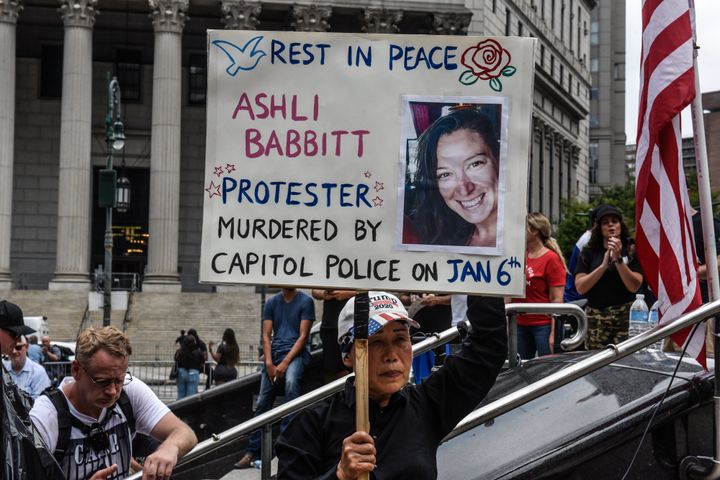 A right wing protester holds a sign about Ashli Babbitt while participating in a political rally on July 25, 2021 in New York City.