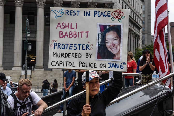 A right wing protester holds a sign about Ashli Babbitt while participating in a political rally on July 25, 2021 in New York City.