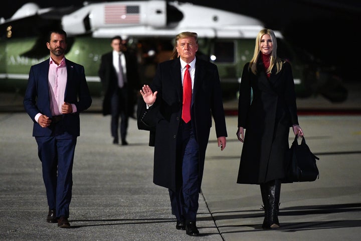 Then-President Donald Trump (C), daughter and Senior Advisor Ivanka Trump and son Donald Trump Jr. (L) make their way to board Air Force One before departing from Dobbins Air Reserve Base in Marietta, Georgia on January 4, 2021. (Photo by MANDEL NGAN/AFP via Getty Images)