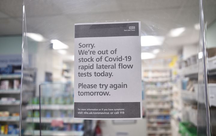 A sign in a chemist's shop displays they are out of stock of government-provided Covid-19 lateral flow tests in Cheadle, England.