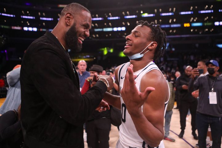 LeBron James comes onto the court to congratulate his son, Bronny, James after his team won a game at the Staples Center on Dec. 4, 2021, in Los Angeles.