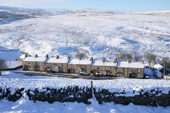 Snow covered fields and rooftops in Allenheads in the Pennines to the north of Weardale in Northumberland.