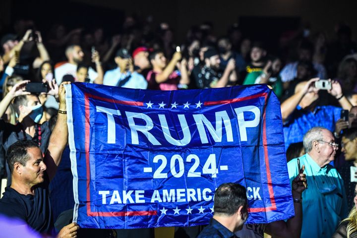 Supporters of former President Donald Trump hold a flag reading "Trump 2024" as he hosts the Holyfield vs. Belford boxing match at the Hard Rock Live in Hollywood, Florida, on Sept. 11, 2021.
