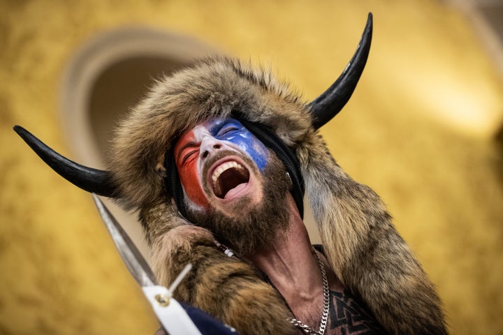 Jacob Chansley, also known as the "QAnon Shaman," screams "Freedom" inside the U.S. Senate chamber on January 6, 2021.