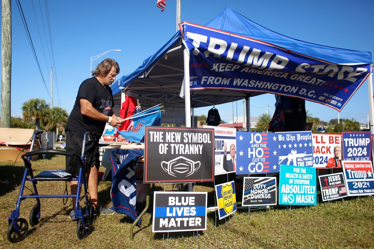 Phil Heck sells right-wing merchandise by a road in Brevard County, Florida, on Dec. 16.