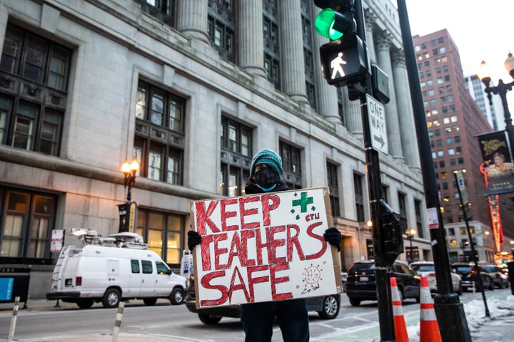 Adan Meza, 29, a teacher at Benito Juarez High School, poses for a photo as he protests with other members of the Chicago Teachers Union and supporters while the union stages a car caravan protest outside City Hall in the Loop, Wednesday evening, Jan. 5, 2022. Chicago school leaders canceled classes in the nation’s third-largest school district for the second straight day after failing to reach an agreement with the teachers union over remote learning and other COVID-19 safety protocols.