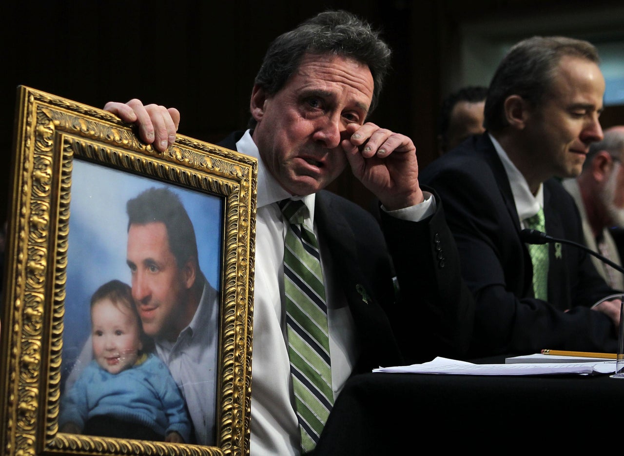 Neil Heslin, father of 6-year-old Sandy Hook Elementary School shooting victim Jesse Lewis, testifies during a hearing before the Senate Judiciary Committee in February 2013. During the testimony, Heslin held a photo of him and Jesse.