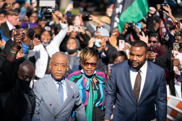 Ahmaud Arbery's mother Wanda Cooper-Jones (center), attorney Lee Merritt (right), right, and Rev. Al Sharpton (left) are greeted outside the Glynn County Courthouse following guilty verdicts for the defendants in the trial of the killers of Ahmaud Arbery on Nov. 24, 2021, in Brunswick, Georgia.