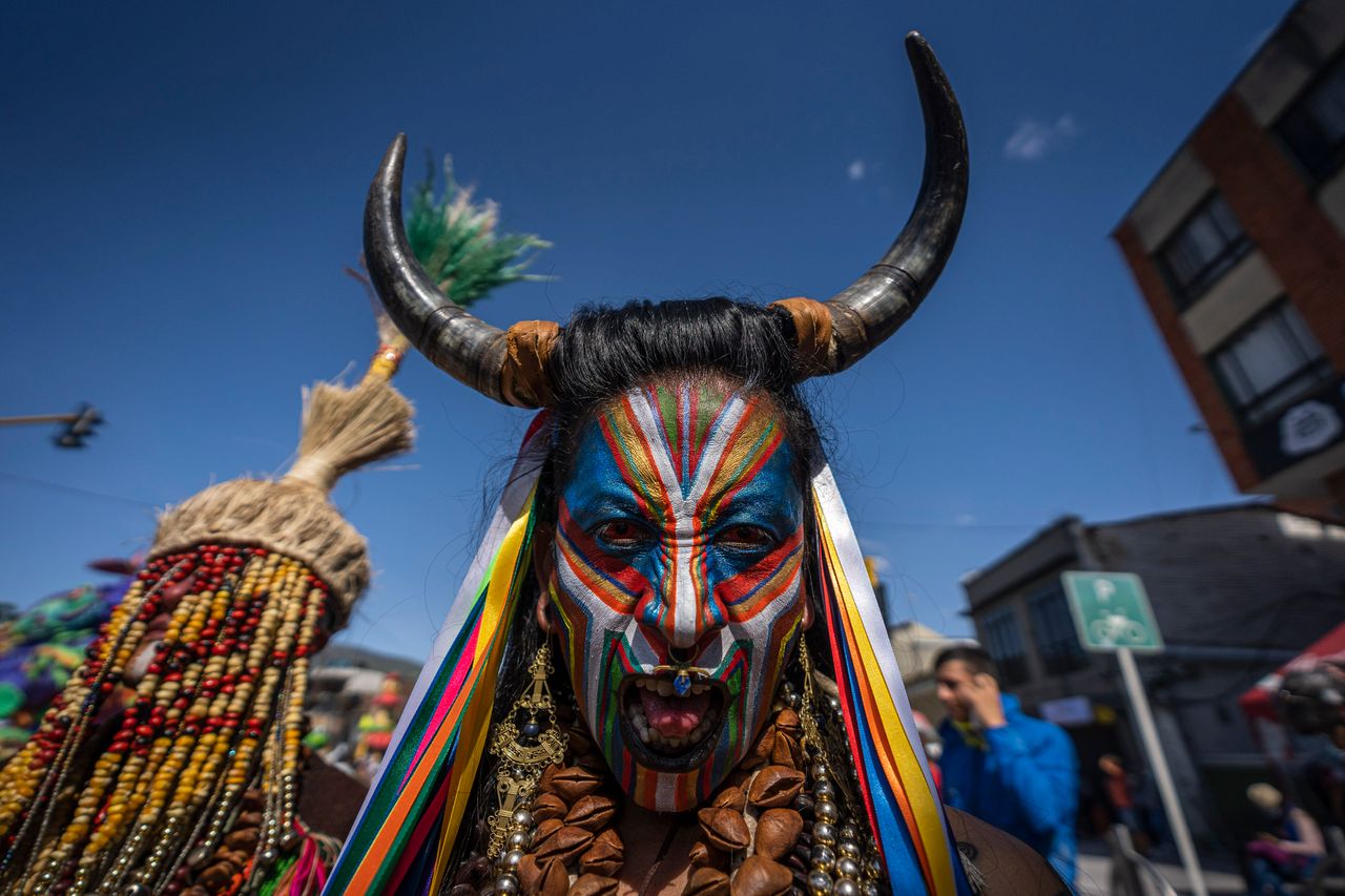 A man wearing a traditional carnival disguise and face paint takes part in the Negros y Blancos Carnival on Thursday in Pasto, Colombia.