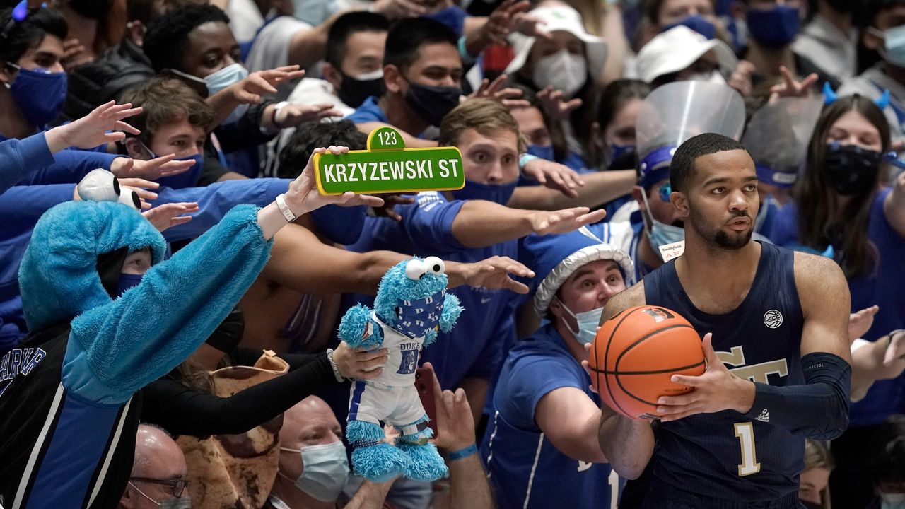 Fans of Duke University reach out while Georgia Tech guard Kyle Sturdivant looks to put the ball inbound during the second half of an NCAA college basketball game in Durham, North Carolina, on Tuesday.