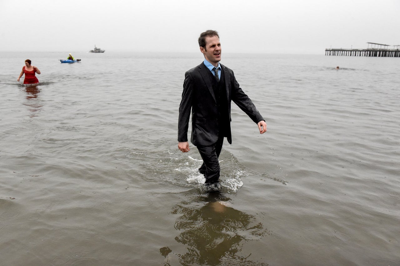 People participate in the annual Polar Bear Plunge in New York City's Coney Island on Saturday. The event returned this year after a hiatus in 2021 due to COVID-19.