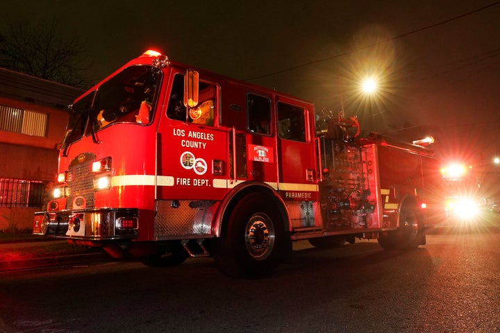 Los Angeles County Fire Department vehicles sit at a medical call on Jan. 7 in Inglewood, Calif. Occasionally, firefighters transport patients to the hospital in fire engines because of short staffing amid an explosion in omicron-fueled coronavirus infections at an ambulance company that the fire department contracts with.