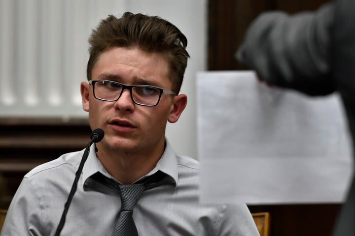 Dominick Black looks at a group photograph including himself, Kyle Rittenhouse and others, held by Assistant District Attorney Thomas Binger during Rittenhouse's trial on November 2, 2021 in Kenosha, Wisconsin.
