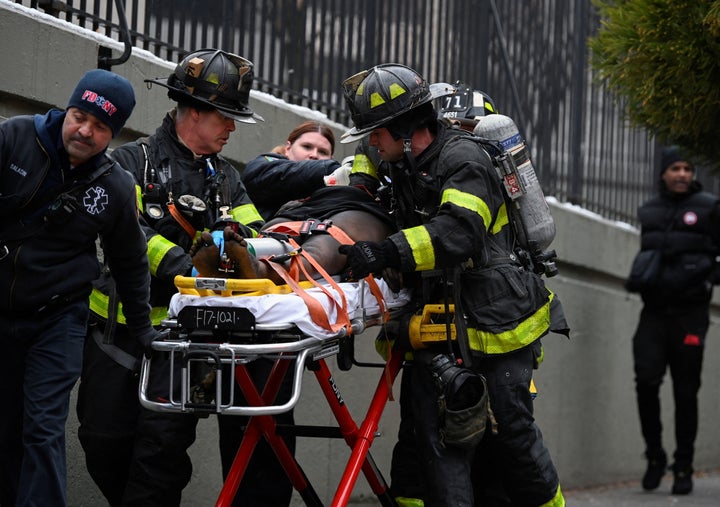 Medical aid is provided to a victim of a five-alarm fire in New York City on Sunday. The fire was one of the city's worst in modern times.