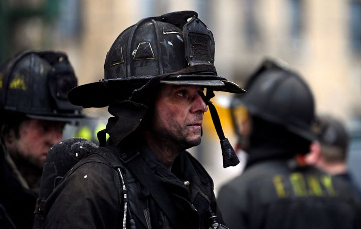 Emergency personnel from the FDNY are seen responding to an apartment building fire in the Bronx on Sunday.