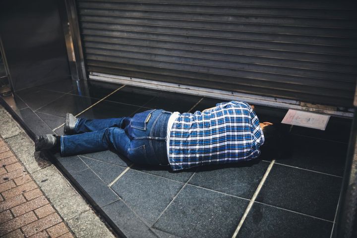 Τόκιο, Ιαπωνία 8 Αυγούστου 2019: Ιάπωνας πωλητής κοιμάται στο πεζοδρόμιο στο Shinjuku Ward. Ο ύπνος στο πεζοδρόμιο είναι κάτι κοινωνικά αποδεκτό στην Ιαπωνία, όπου οι υπερωρίες κατά τις νυχτερινές ώρες συνηθίζονται γενικά.