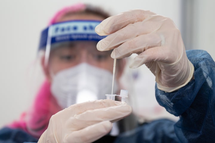 Carina Dozauer evaluates a COVID-19 quick test in a test center in front of the Prohlis Kombibad in Dresden, Germany on January 11, 2022. (Photo by Sebastian Kahnert/picture alliance via Getty Images)