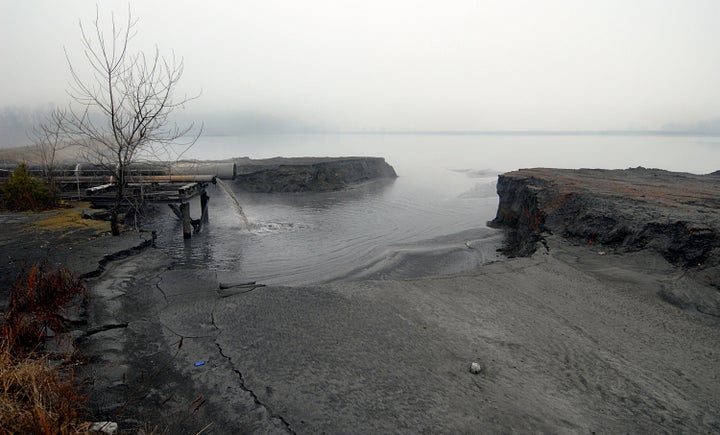 Coal ash slurry pours into the first of two settling ponds adjacent to the Riverbend Steam Station on Mountain Island Lake in Gaston County, North Carolina, in 2008.