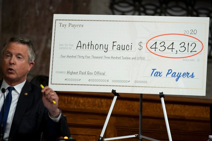 Sen. Roger Marshall (R-Kan.) shows the yearly pay of Dr. Anthony Fauci, director of the National Institute of Allergy and Infectious Diseases, during a Senate health committee hearing at Capitol Hill in Washington, D.C., on Tuesday.