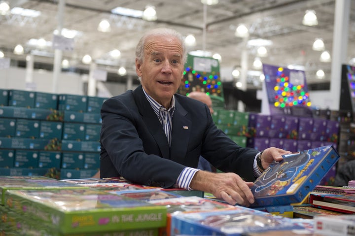 Then-Vice President Joe Biden selects books to give as gifts to charity during a visit to a Costco store on a shopping trip in Washington, D.C., on Nov. 29, 2012.